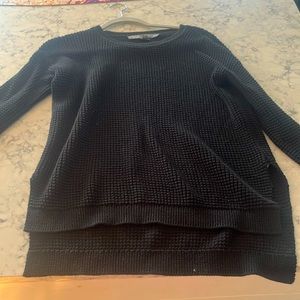 This is a black ribbed sweater that is longer in the back. It’s very comfortable
